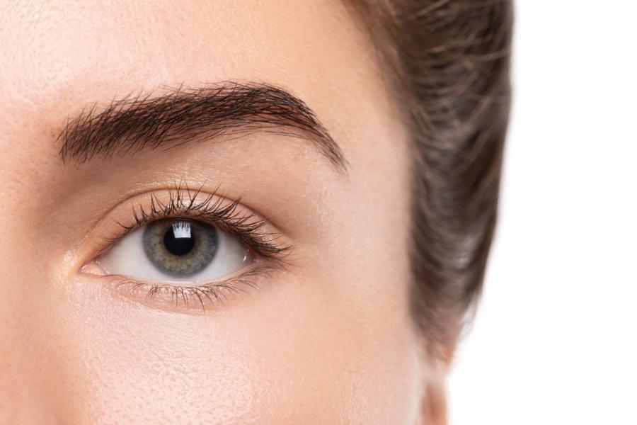Closeup of young female eye without makeup with a copy space